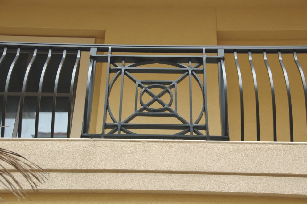 An architectural balcony railing with an intricate decorative design.
