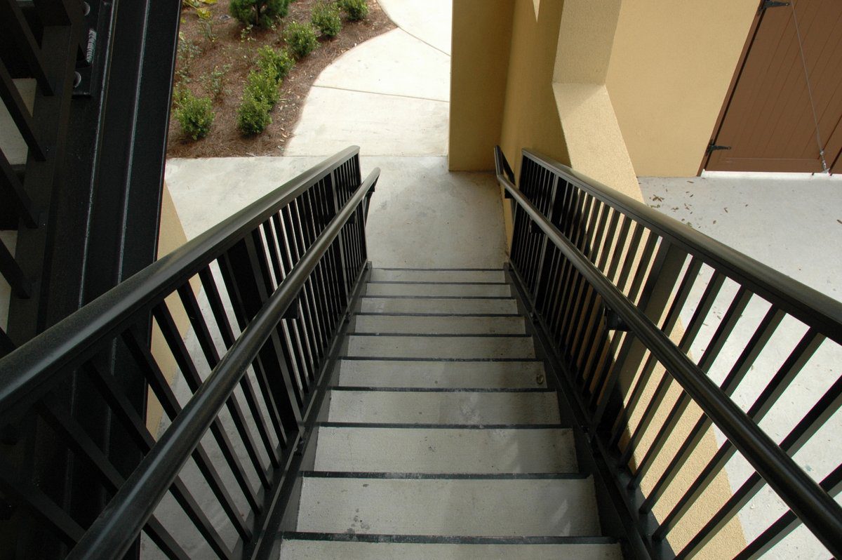 A stairway with sleek black Architectural Railings.